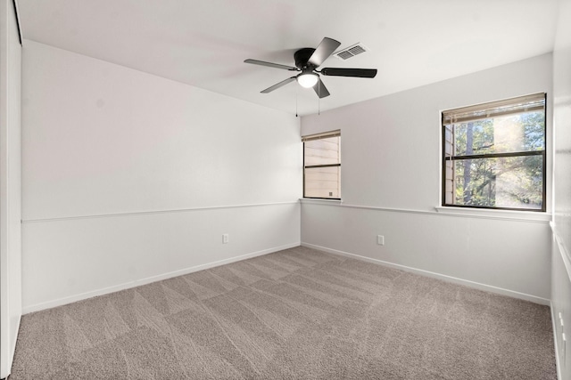 empty room featuring carpet flooring and ceiling fan