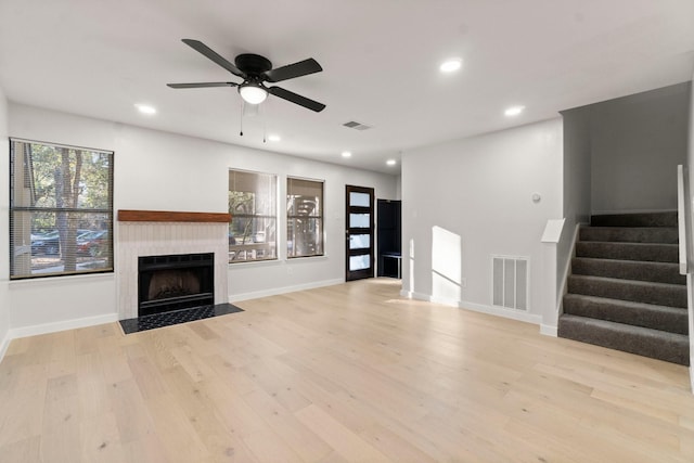 unfurnished living room with ceiling fan and light wood-type flooring