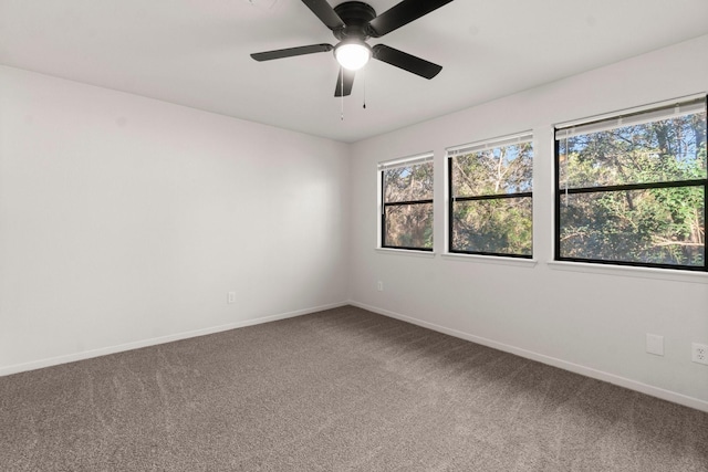 carpeted empty room featuring plenty of natural light and ceiling fan