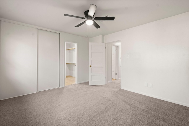 unfurnished bedroom featuring carpet flooring, a closet, and ceiling fan