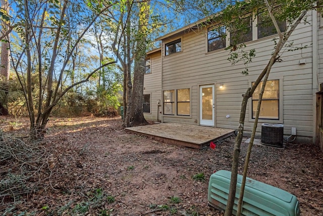 rear view of property with central AC