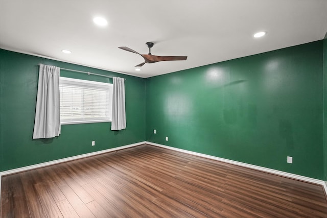 spare room with wood-type flooring and ceiling fan