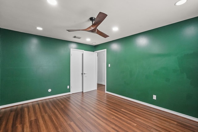 spare room featuring dark hardwood / wood-style floors and ceiling fan