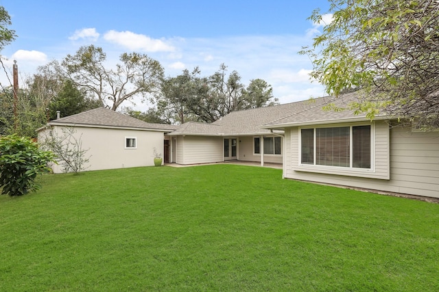 back of house with a lawn