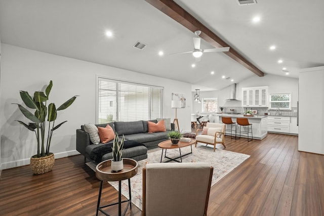 living room with vaulted ceiling with beams, ceiling fan, sink, and dark hardwood / wood-style floors