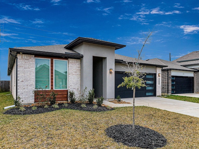 prairie-style home featuring a front yard and a garage