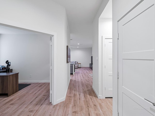 hallway with light hardwood / wood-style flooring