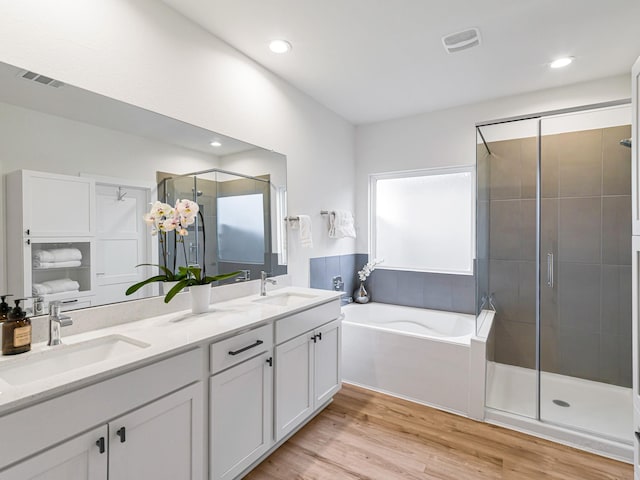 bathroom featuring vanity, separate shower and tub, and wood-type flooring