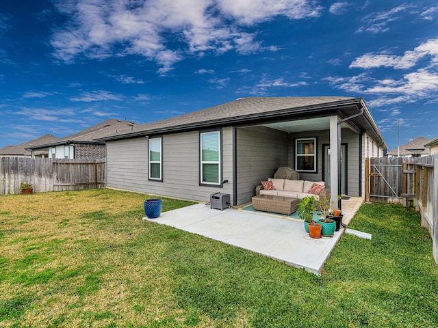 back of house featuring an outdoor living space, a patio area, and a lawn