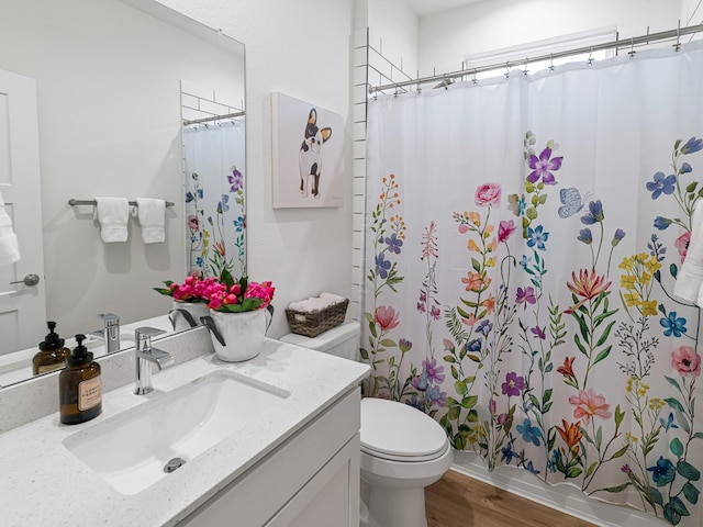 bathroom featuring a shower with shower curtain, vanity, toilet, and hardwood / wood-style flooring