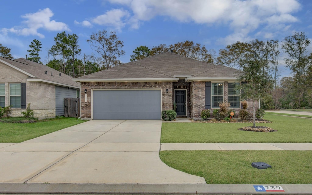 ranch-style house with a garage and a front yard