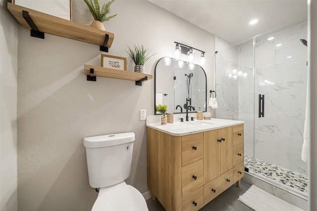 bathroom featuring walk in shower, vanity, and toilet