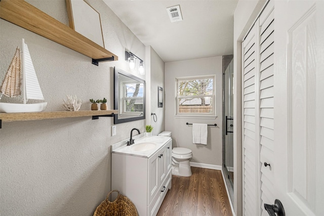 bathroom featuring vanity, hardwood / wood-style flooring, and toilet