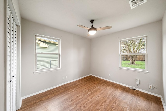 empty room featuring hardwood / wood-style flooring and ceiling fan