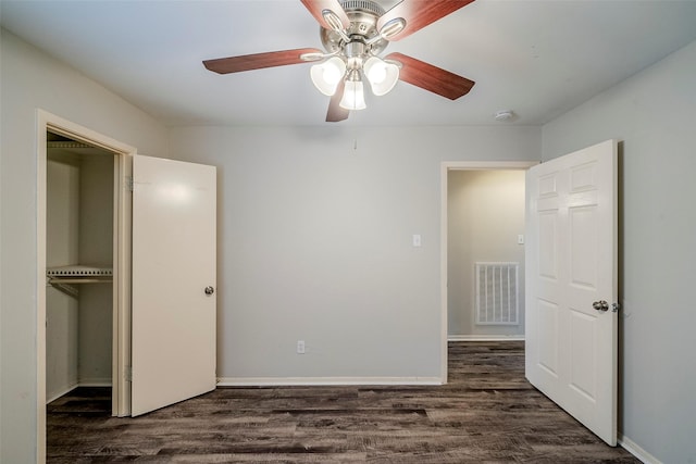 unfurnished bedroom featuring ceiling fan, dark wood-type flooring, and a closet