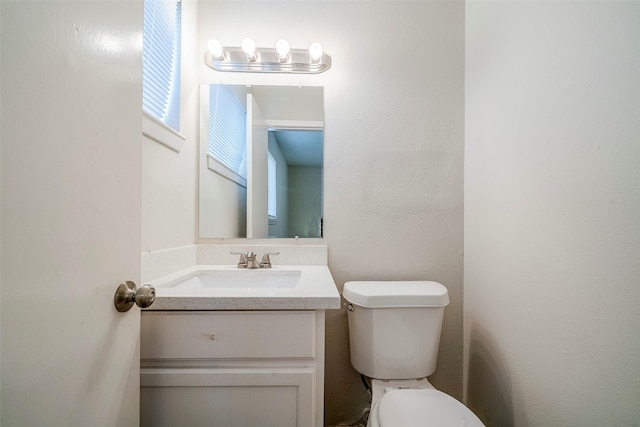 bathroom with toilet and vanity