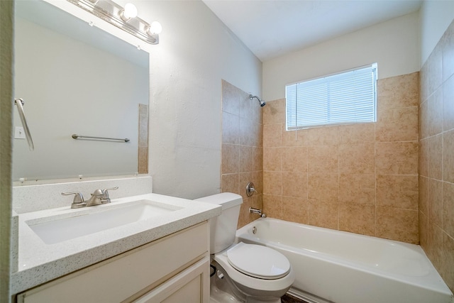 full bathroom with toilet, vanity, and tiled shower / bath