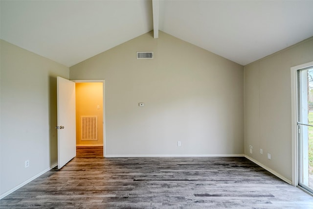 empty room with wood-type flooring and vaulted ceiling with beams