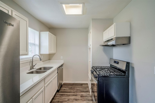 kitchen featuring dark wood-type flooring, sink, white cabinets, and stainless steel appliances