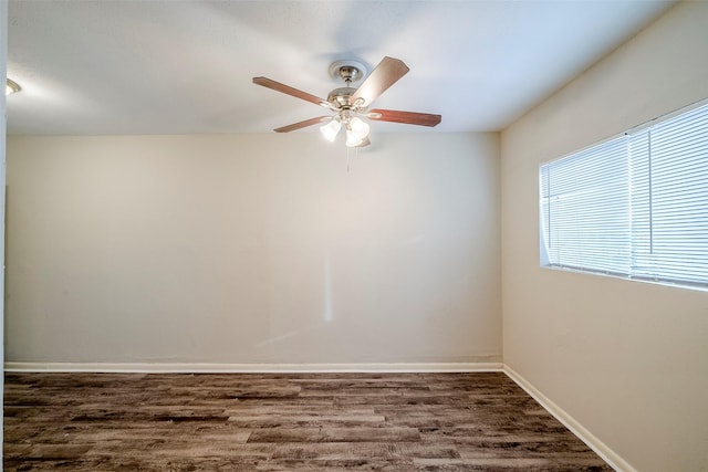 spare room with ceiling fan and dark hardwood / wood-style flooring