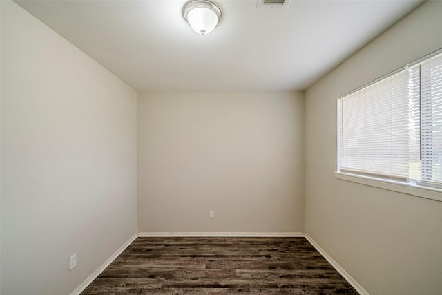 unfurnished room featuring dark hardwood / wood-style floors