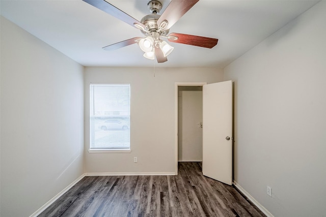 unfurnished bedroom featuring ceiling fan and dark wood-type flooring