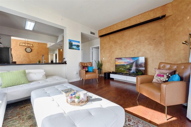 living room featuring sink and hardwood / wood-style flooring