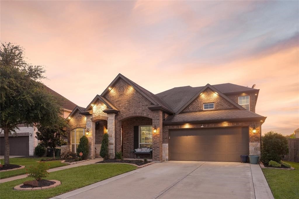 view of front of property featuring a yard and a garage