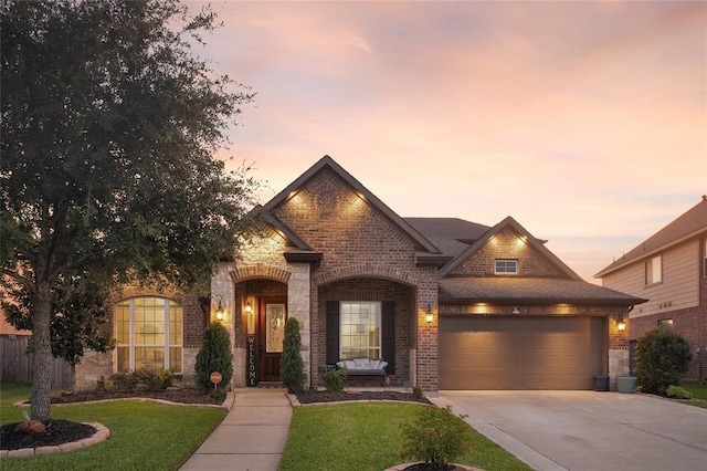 view of front of property with a lawn and a garage