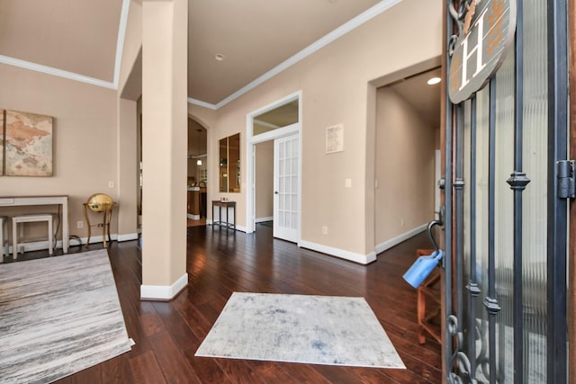 foyer entrance with crown molding and dark wood-type flooring