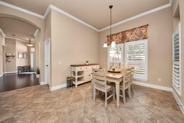 dining room featuring crown molding and a chandelier