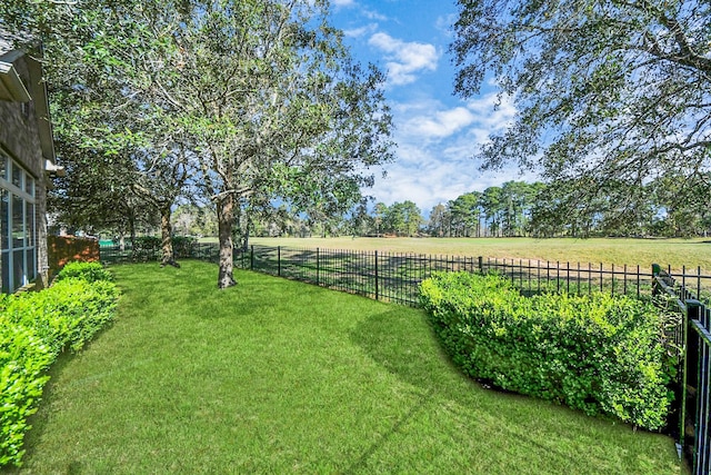 view of yard featuring a rural view and fence