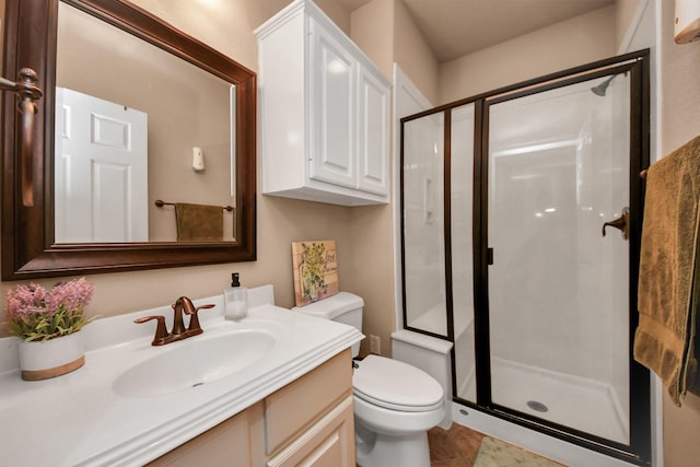 bathroom with vanity, an enclosed shower, and toilet