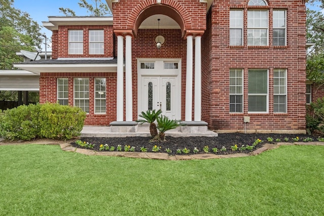 entrance to property with a lawn