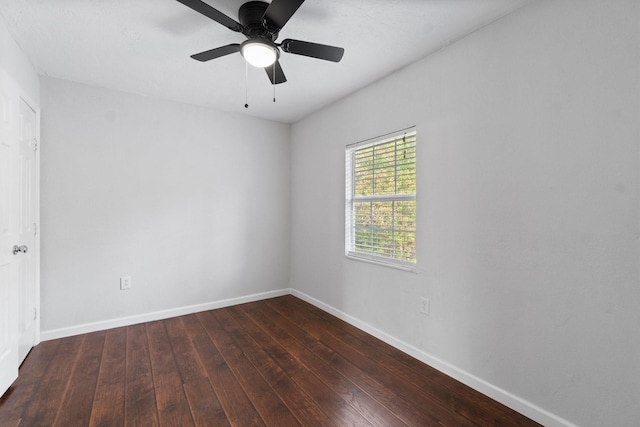 empty room featuring ceiling fan and dark wood-type flooring