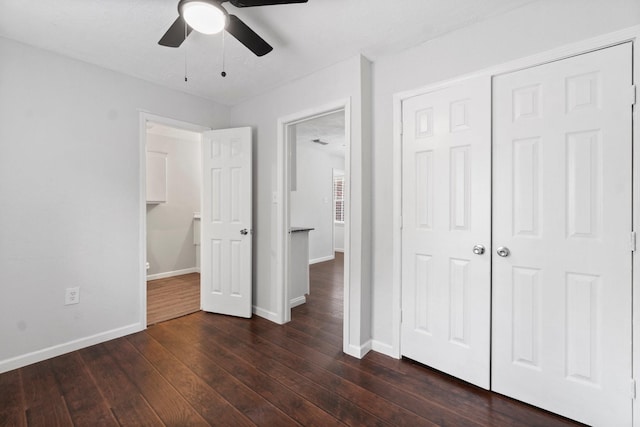 unfurnished bedroom featuring a closet, ceiling fan, and dark wood-type flooring