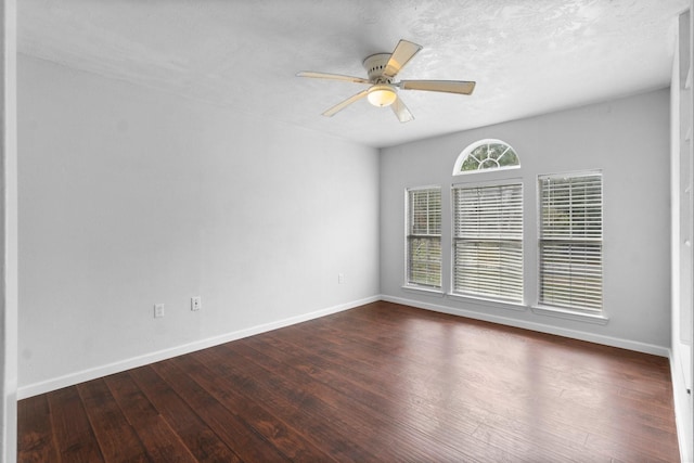 spare room featuring a textured ceiling, ceiling fan, and dark hardwood / wood-style floors