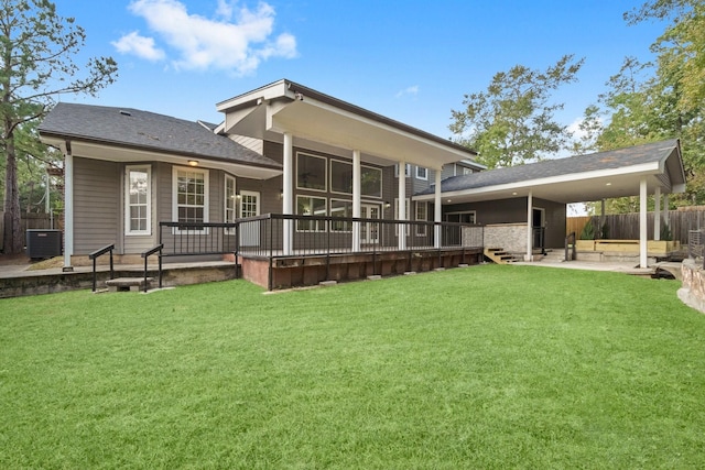 back of house with a wooden deck, central AC unit, a patio area, and a lawn