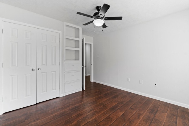 unfurnished bedroom featuring ceiling fan, dark hardwood / wood-style flooring, and a closet