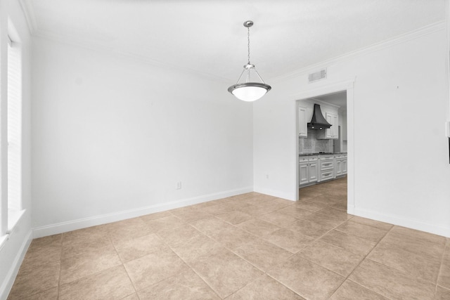 empty room featuring crown molding and light tile patterned flooring