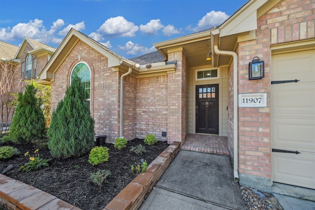 view of exterior entry with a garage