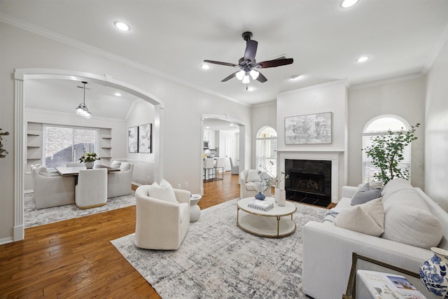 living room featuring plenty of natural light, a tile fireplace, ceiling fan, and hardwood / wood-style floors