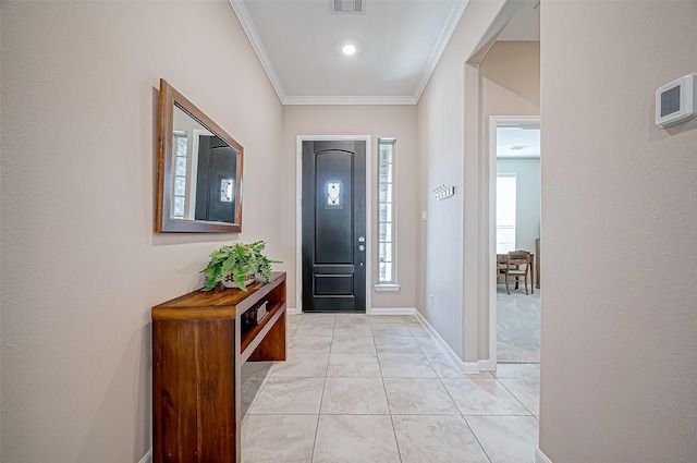 tiled foyer entrance with ornamental molding