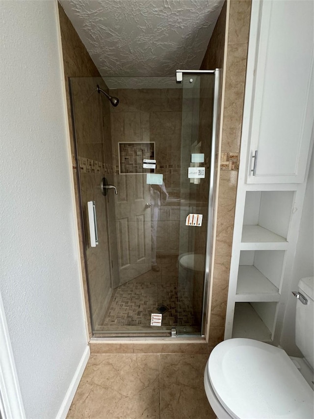 bathroom featuring toilet and walk in shower