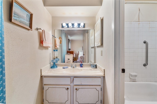 bathroom with vanity and tiled shower / bath combo