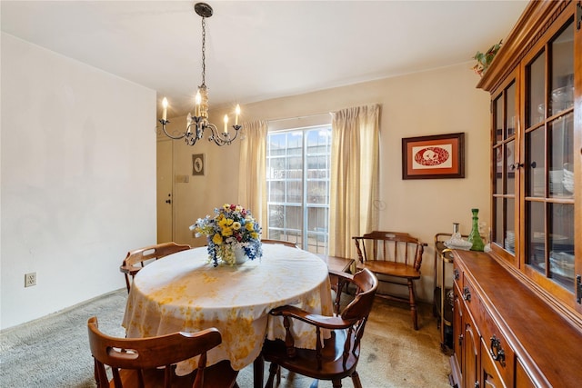 dining room with light carpet and an inviting chandelier