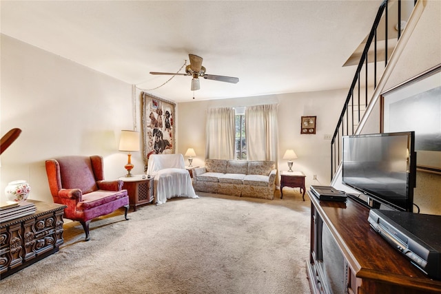 carpeted living room with ceiling fan