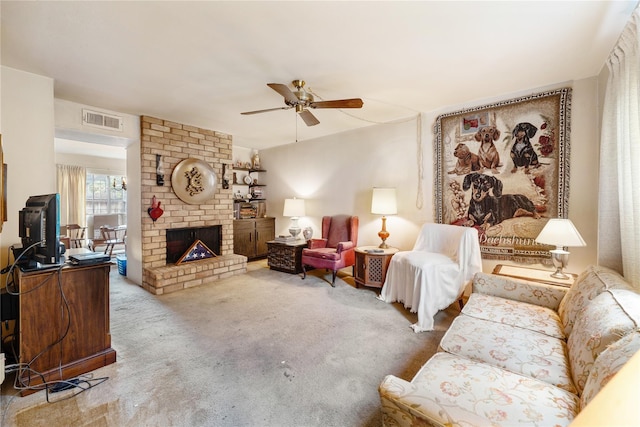 carpeted living room with a fireplace and ceiling fan