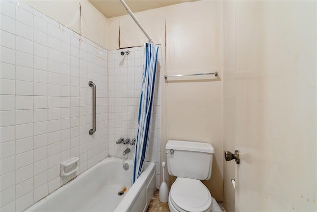 bathroom featuring shower / tub combo and toilet