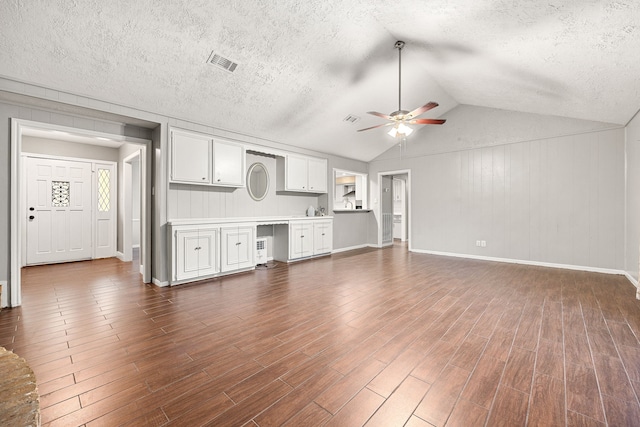 unfurnished living room featuring ceiling fan and lofted ceiling